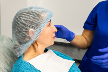 Woman Spa specialist consults a girl sitting in a chair