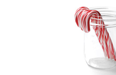 Candy Canes in Jar on White Background for Festive Christmas Decoration