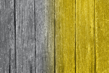 Gradient Ultimate Gray and Illuminating yellow wooden surface toned in trendy colors of 2021.