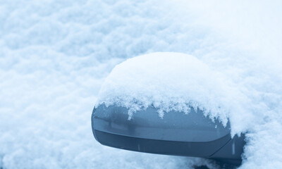 Car mirror in the snow. Winter concept.