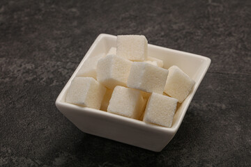 Refined white sugar cubs in the bowl