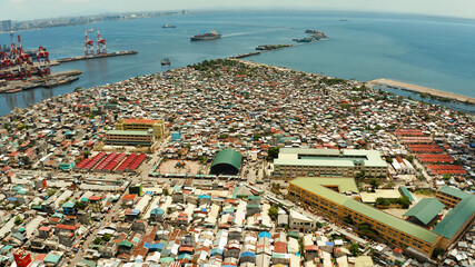 Poor area in the slums of Manila with density houses and streets from above.