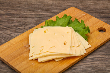 Sliced yellow cheese over board