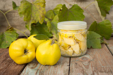 Ripe quince, preserved candied quince in sugar. Yellow quince on a wooden background.