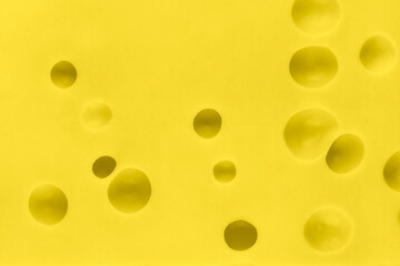 Close up texture of yellow cheese. Cheese with big holes. Food background.
