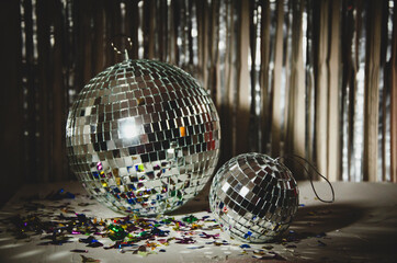 Silver Disco ball, star confetti, silver and gold metallic background.
