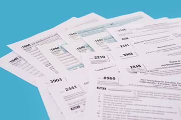 Obraz premium Tax concept. Many different usa tax form. 1040 form for fill in April.