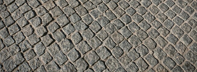 a fragment of a gray stone paving stone on the road