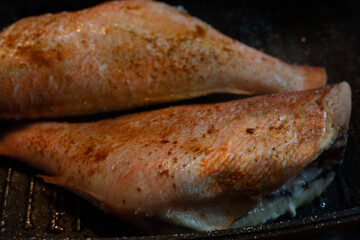 Cooking sea bass in a pan