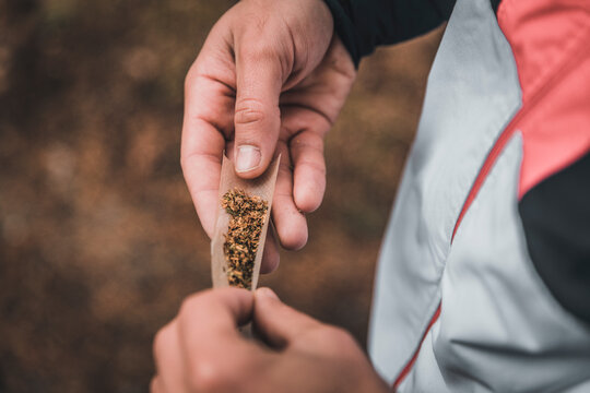 Hands of man rolling joint