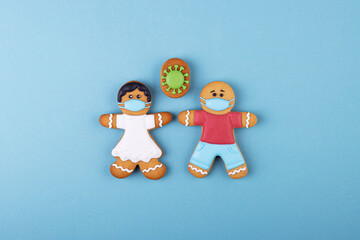 Gingerbread boy and girl in medical masks, gingerbread coronavirus
