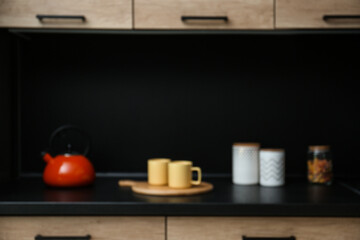 Fototapeta na wymiar Blurred view of kitchen interior with modern furniture