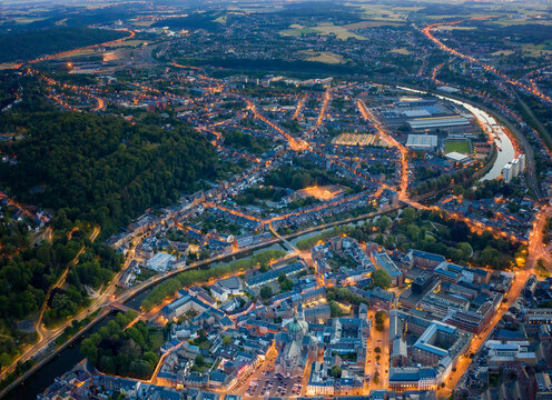 Belgium, Namur Province, Namur, Aerial view of riverside city at dusk