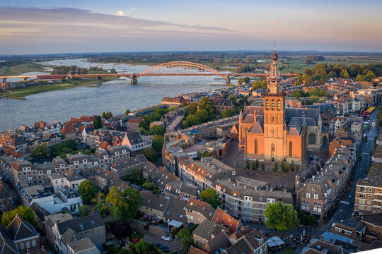 Netherlands, Gelderland, Nijmegen, Aerial view of Saint Stephens Church and surrounding buildings at dusk
