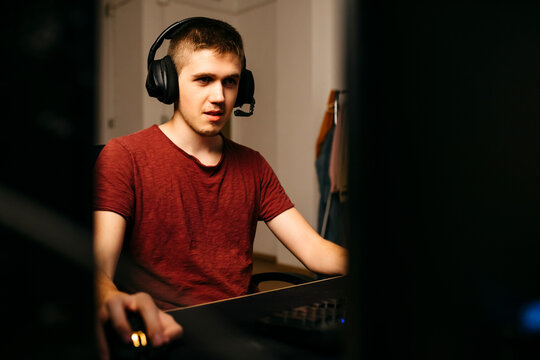 Young man playing video games with computer at desk