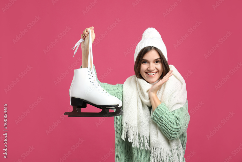 Canvas Prints Emotional woman with ice skates on pink background