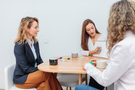 Woman explaining chart on note pad at office