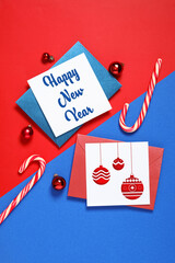 Flat lay composition with greeting cards and Christmas decor on color background. Happy New Year