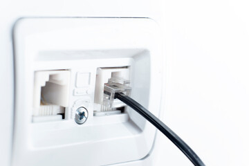 telephone socket and telephone cable on the wall