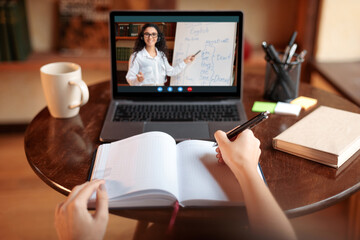 Student using laptop having online class with teacher, pov - obrazy, fototapety, plakaty