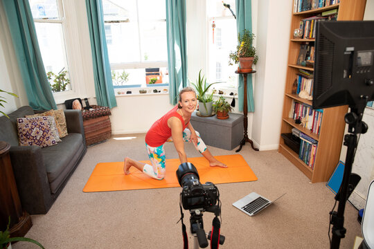 Fitness Woman Doing Exercise Video Recording With Camera At Home