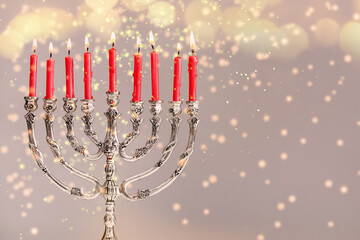 Silver menorah with burning candles on light background, space for text. Hanukkah celebration