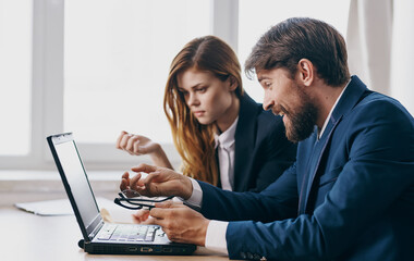 Man and woman in suits work laptop finance manager