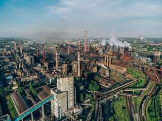 Industry metallurgical plant or chemical factory with coal, pipes, blast furnaces and many smog pollution, aerial view.