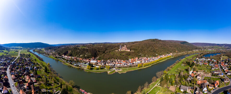 Germany, Bavaria, Stadtprozelten, Helicopter view of riverside town in autumn with Henneburg castle in background