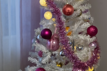 Fototapeta na wymiar White Christmas tree. Decorative balls for the Christmas tree. Close-up.