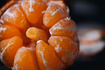 freshly picked tangerines,  on a wooden table and black background