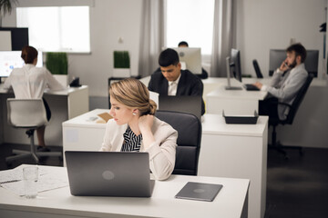 Customer service Manager at the workplace at the table with a laptop