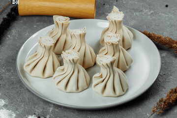 Caucasuan cuisine - Khinkali with meat on a white plate