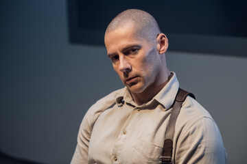 Portrait of a young handsome investigator in the interrogation room.
