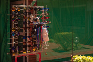A booth offering sunglasses, now chinstraps or face masks have been added for tourists to shop due to the COVID-19 pandemic crisis