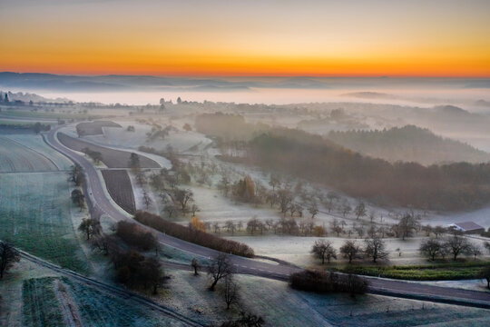 Germany, Baden-Wurttemberg, Berglen, Drone view of countryside road at foggy autumn dawn
