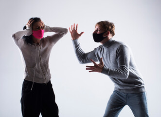 attractive angry couple fighting and shouting at each other. Angry couple. Mask. 

