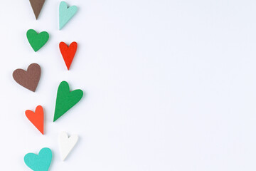 Red, green, brown and blue hearts on a white background. Valentine's Day.