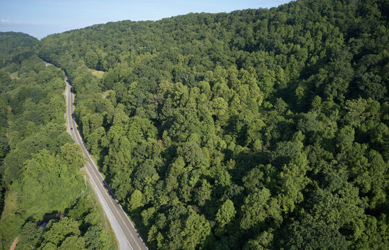 Aerial view of U.S. Route 58 stretching across green alpine forest