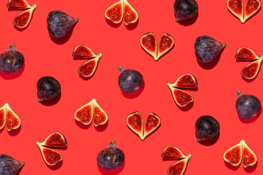 Directly above shot of fig fruit arranged on red background