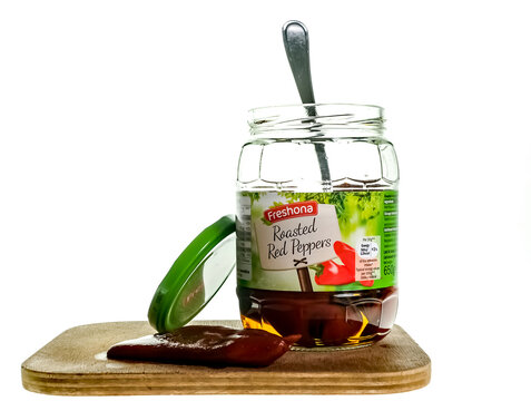 Norwich, Norfolk, UK – December 20 2020. An Illustrative Photo Of A Glass Jar Of Freshona Branded Roasted Red Peppers In Brine On A Plain White Background