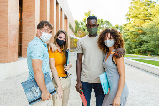 University students wearing protective face mask while standing in campus