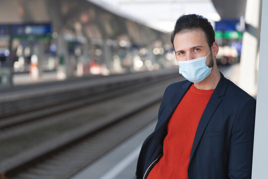 Male entrepreneur wearing protective mask on railroad station platform