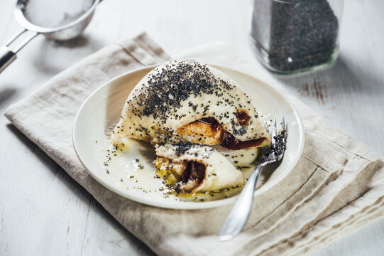 Sweet Germknodel dumpling with poppy seeds and plum jam