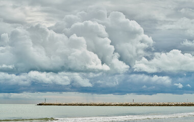 Lighthouse promenade in Caorle, in a cloudy day of September