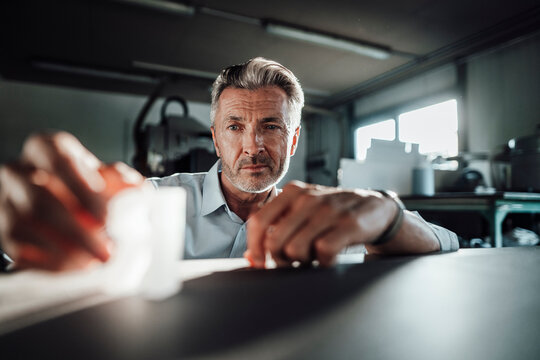 Wrinkled male manager working in factory