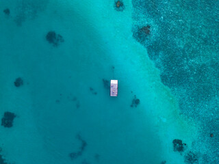 Floating platform on turquoise sea, aerial view