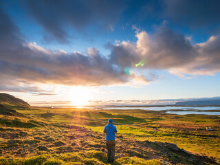Male hiker admiring sunset over Snaefellsnes peninsula, Iceland