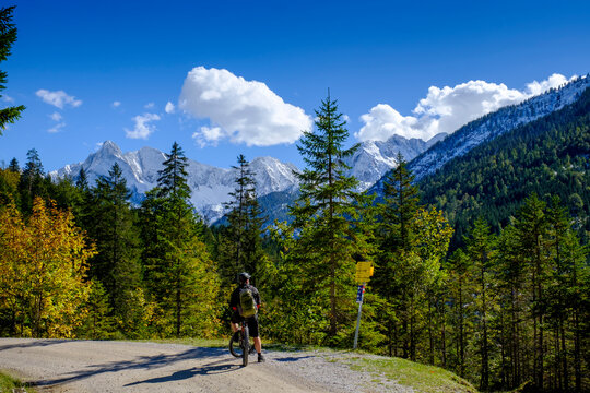 Male biker admiring forestedÔøΩGleirschtal valley in summer