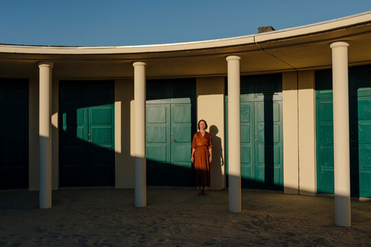 Mid adult woman standing against door in resort at Deauville, France